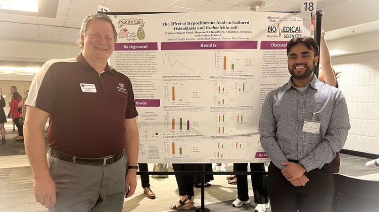 Mayeen Choudhury (right) and Dr. Joshua Smith (left) at a poster presentation.