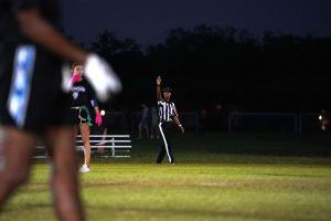 Sanders officiating on the field during a match.