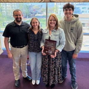 Murray, center right, celebrates receiving the 2026 Curtis P. Lawrence Award for Excellence in Advising with her family.