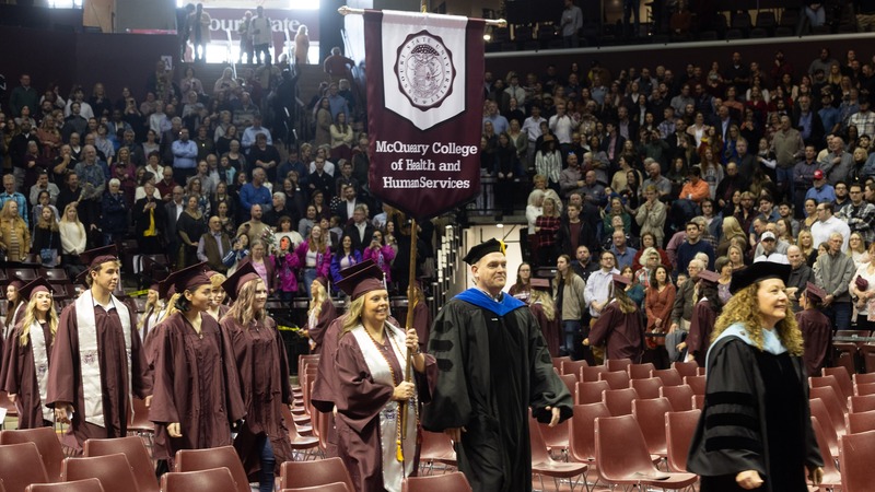 The procession of graduates from the McQueary College of Health and Human Services.