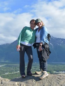 Dudley (left) and Urich with a mountain view behind them. 