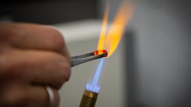 Compound heated to emit yellow flame