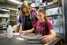 Dr. Mathis works with graduate student Sarah Heimbach