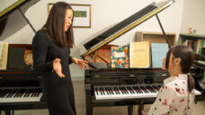 In her office, Minju Choi Witte provides instruction to an MSU student seated at a piano
