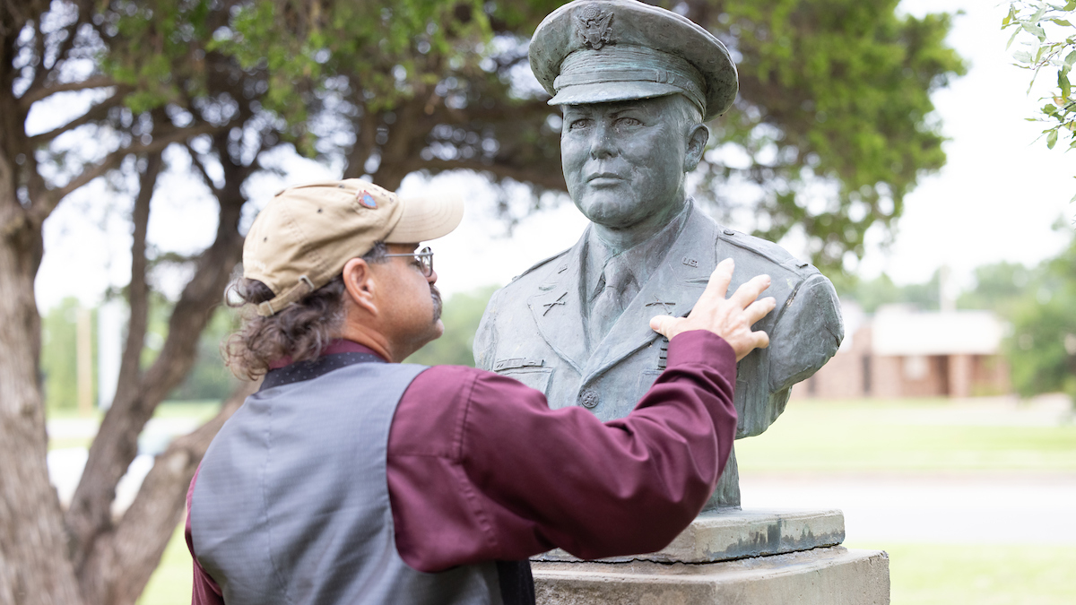 William Meadows touches military veteran bust.