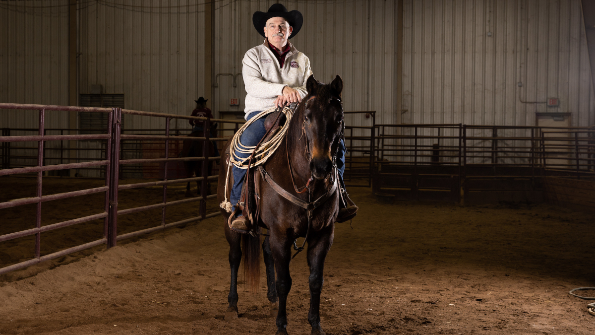 Gary Webb sits on horseback in arena.