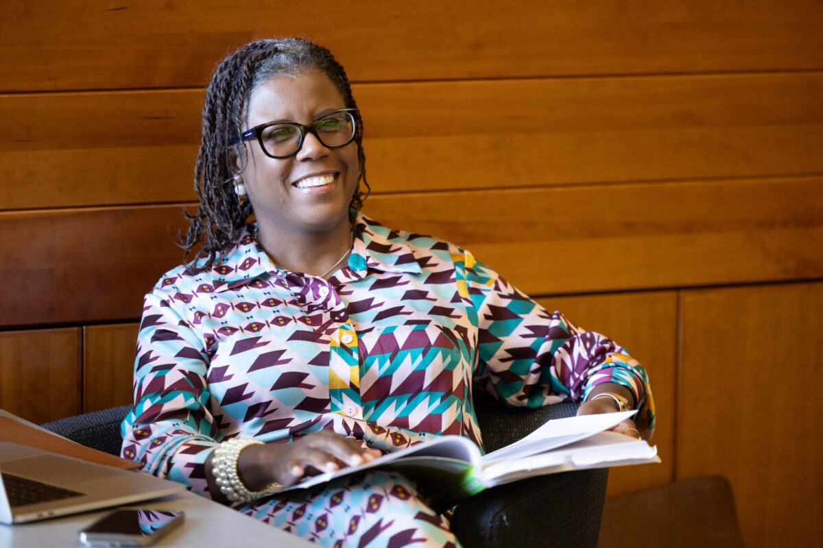 With a book resting on her lap, Dr. Nicole West happily participates in her Wednesday Faculty Writing group session.