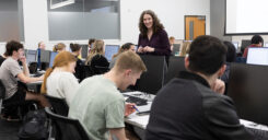 Dr. Adams teaches an accountancy class, as students take notes.