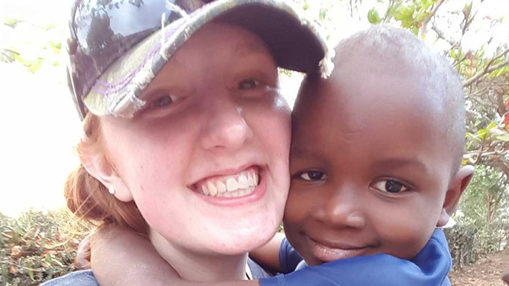 Karlie Beckett and a child in Haiti