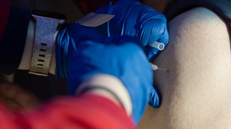 Nurse administering COVID vaccine at Fairgrounds clinic. Photo by MSU visual media team.
