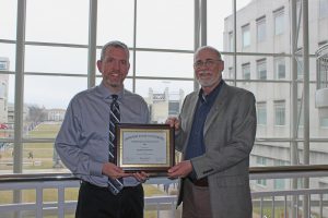 Mike Suttmoeller receives his Certified Distance Educator Award from Dr. Gary Rader
