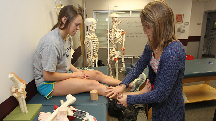 Athletic training student wraps ankle