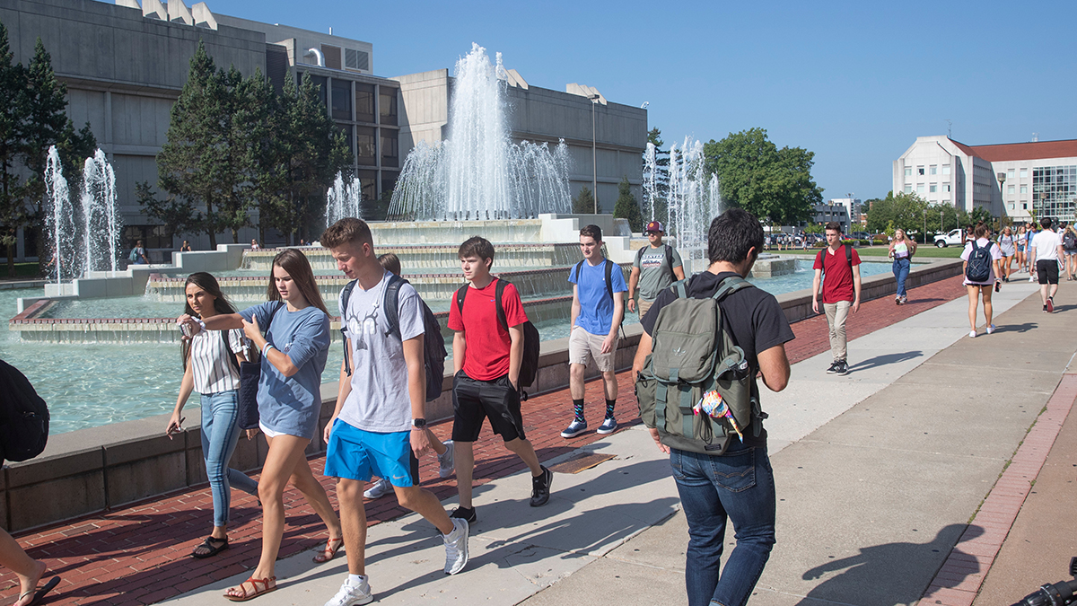 Students walk by fountain