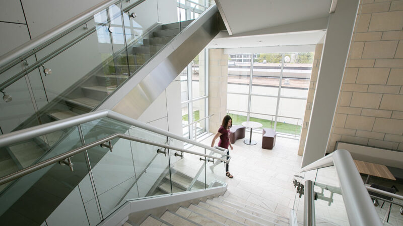 Student walking up stairwell in Magers Health and Wellness Center.