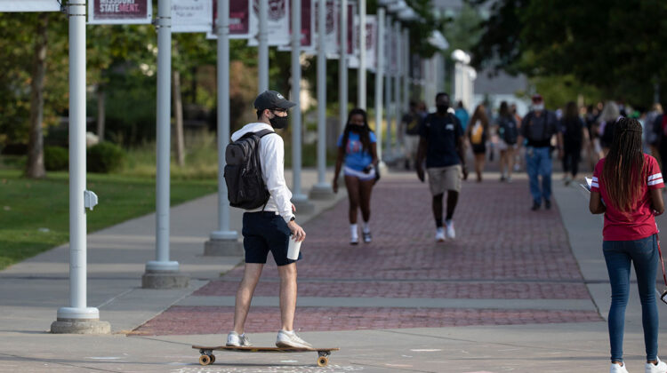 Masked skateboarder travels across campus