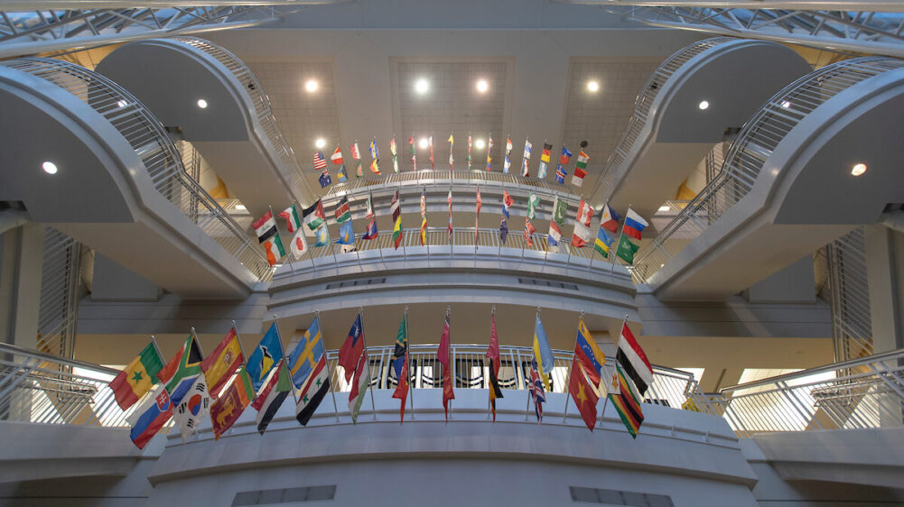 From the ground floor of the Strong Hall atrium, looking up at the flags overhanging the staircase.