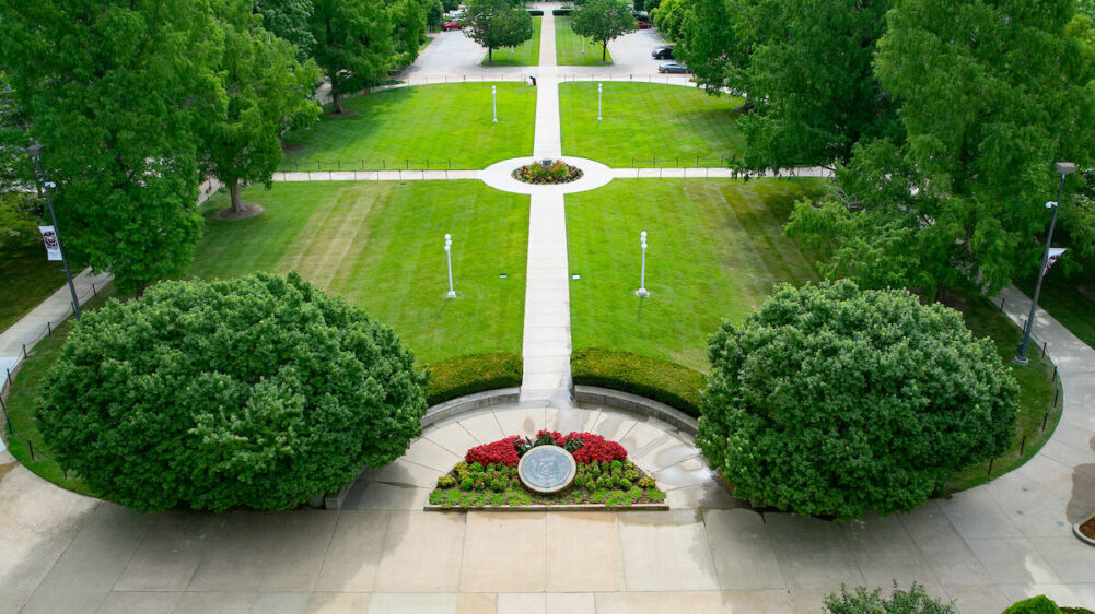 Aerial of historic quad, featuring several green trees..