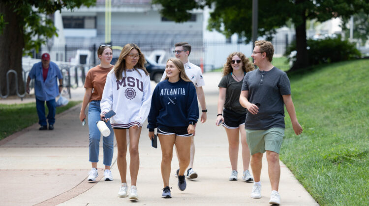 Student walk near Plaster Stadium during move-in.