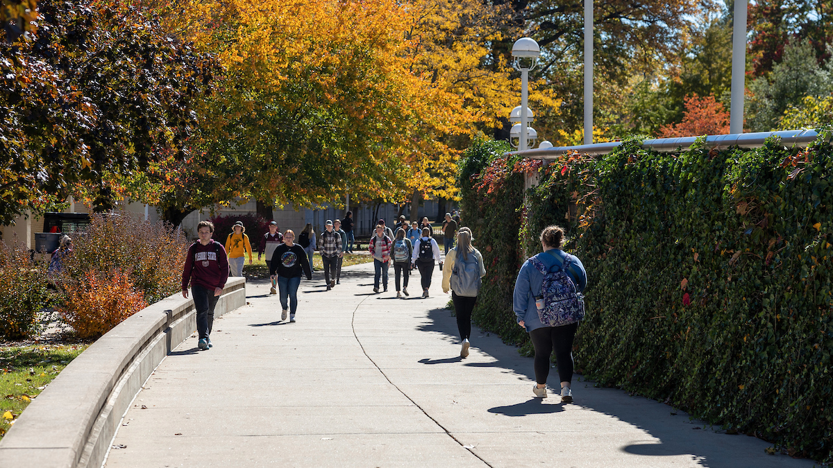 Students walk past legacy wall on Missouri State campus.