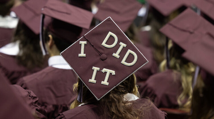 The words "I DID IT" on a graduate's mortarboard.
