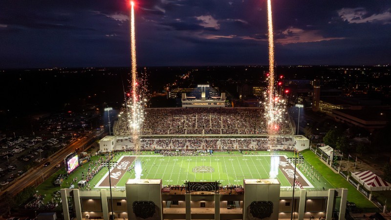 Aerial view of Plaster Stadium at night with fireworks during a home football game.