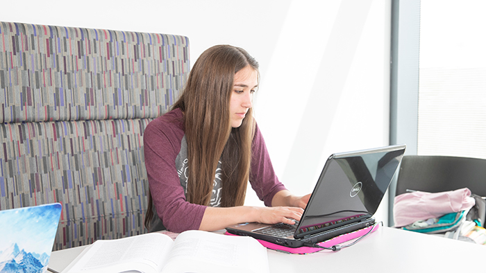 female student using laptop