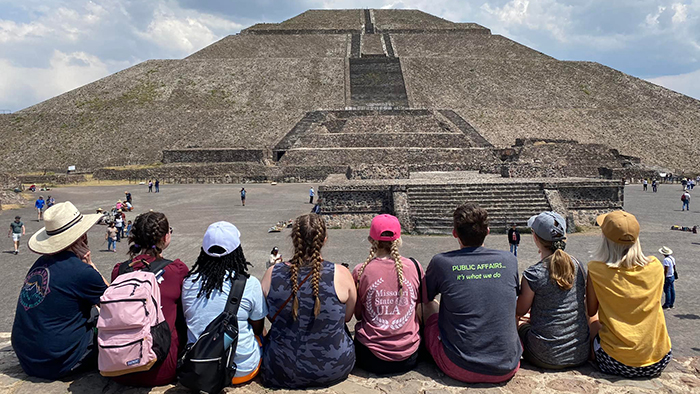students in Mexico looking at pyramid