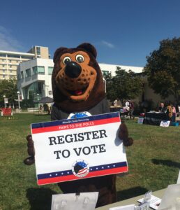 Missouri State's mascot, Boomer, holds a sign that reads "Register to Vote" 