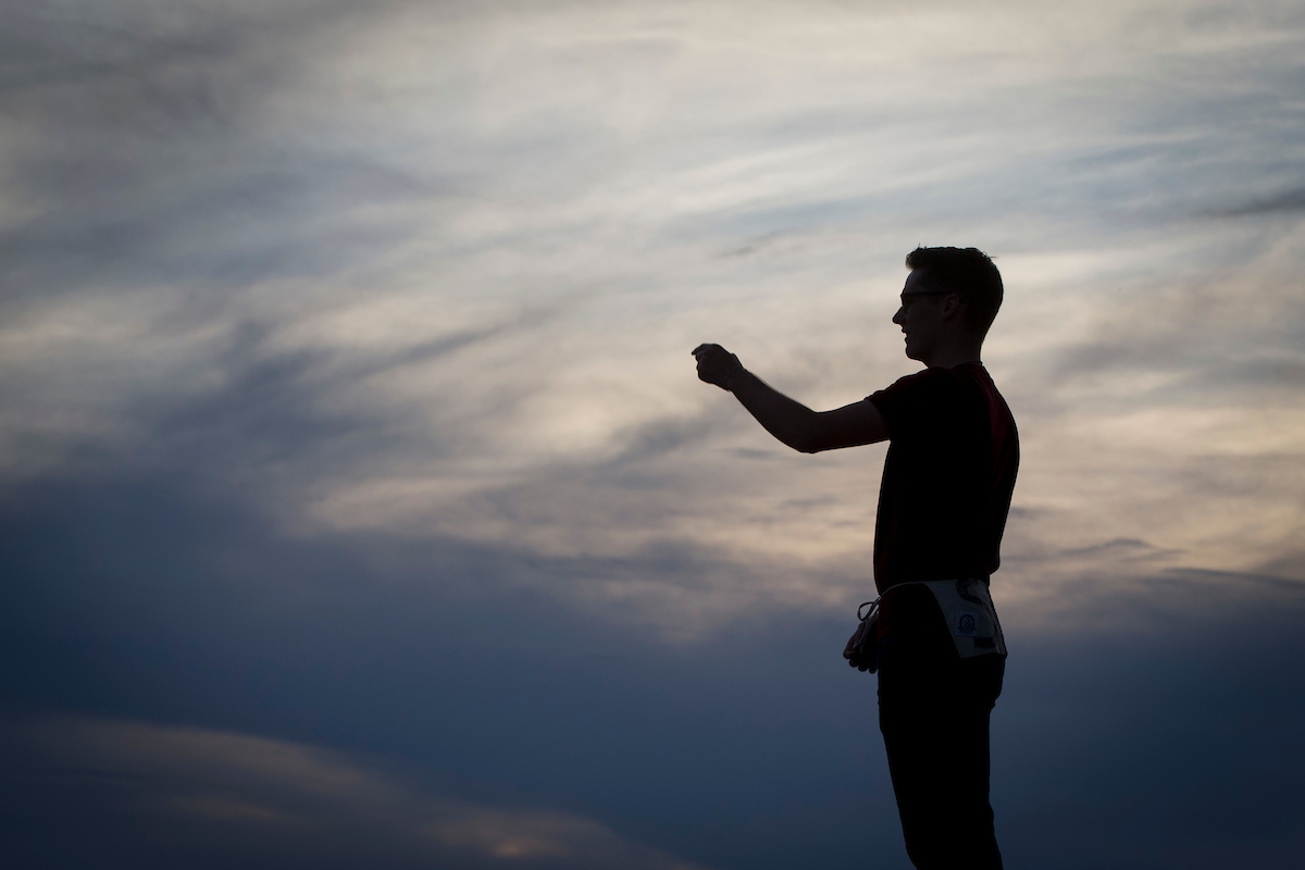 Drum major, silhouetted against the sunset