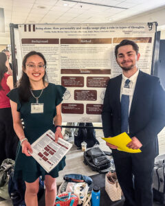 Students standing with their research presentation at the MCHHS Student Research Symposium.