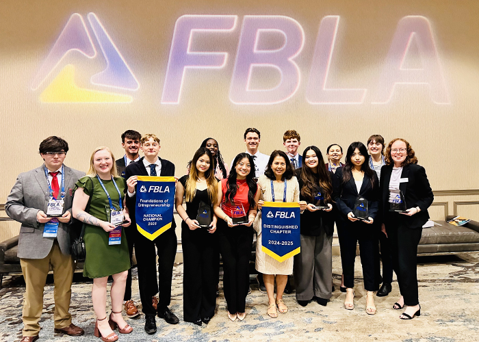 Representatives of Missouri State University's Future Business Leaders of America chapter, holding their Distinguished Chapter Award. 