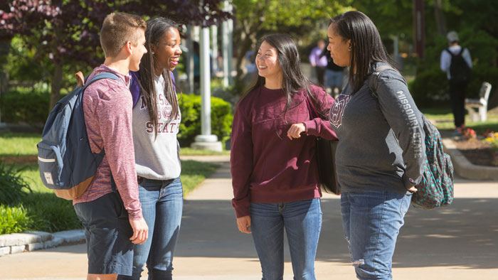 students chat on campus