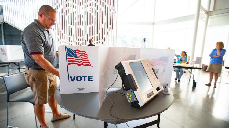 A man votes at the Welcome Center