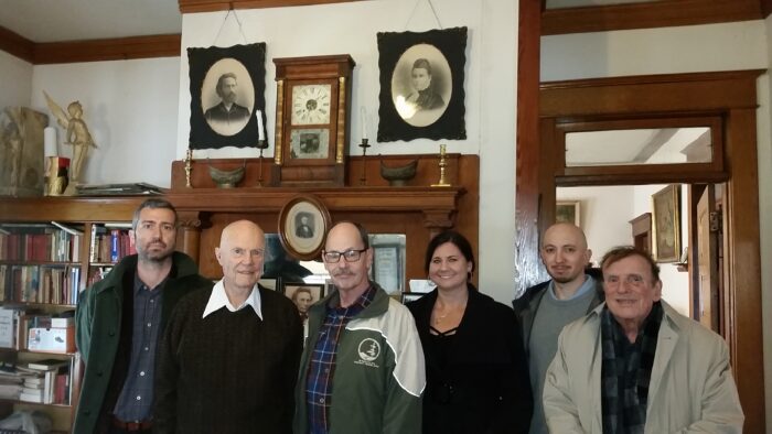photo showing the Thomas Moore Johnson Library with guests Dr. Vadim Putzu (MSU), Tom Johnson (TMJ's grandson), and others