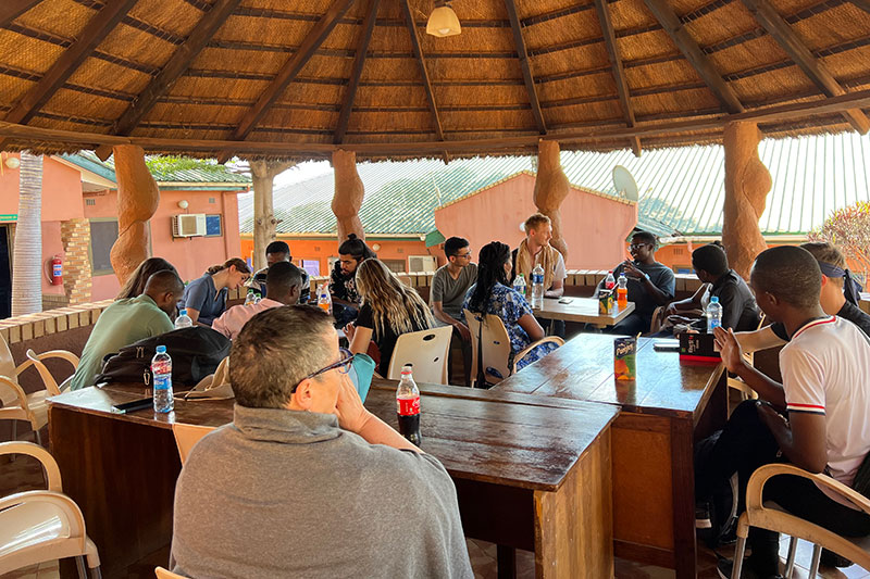 Group of people at several tables.