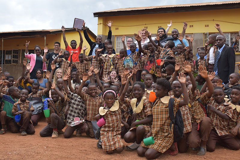 Group photo smiling with hands in air