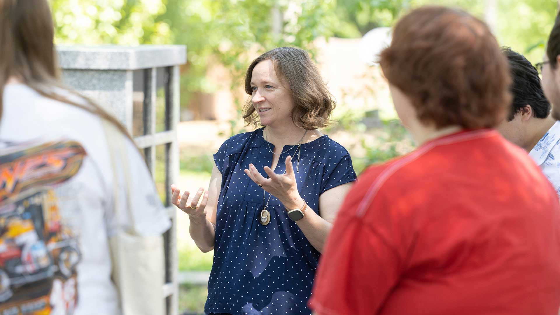 Dr. Marnie Watson speaks to a group of people.
