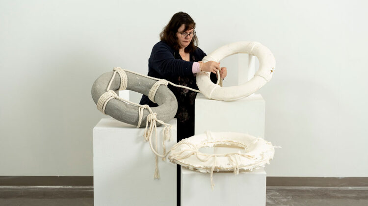 Woman working with sculpture exhibit