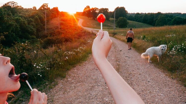 Hand holding up lollipop to the sun