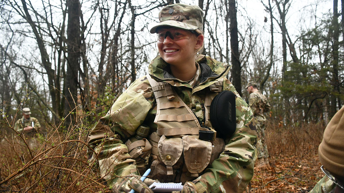 Female standing outside in military gear