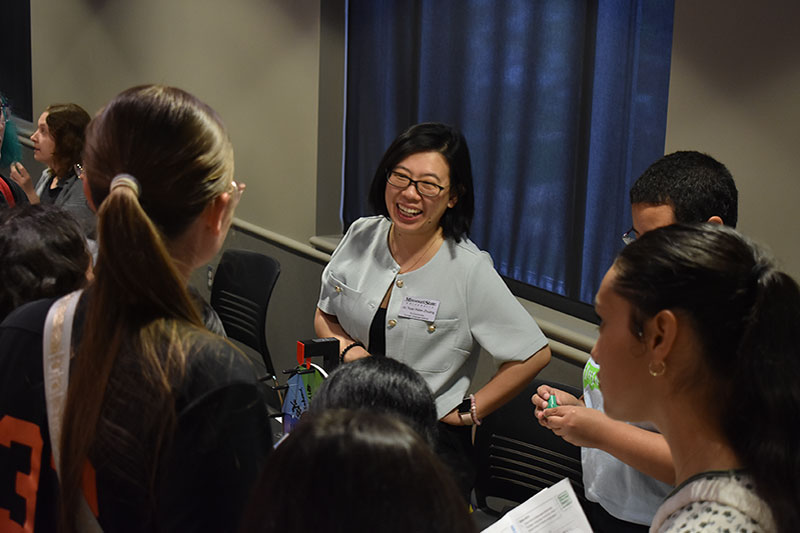 Dr. Helen Zhuang laughs with students