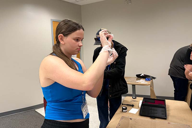Young woman using fingerprint kit