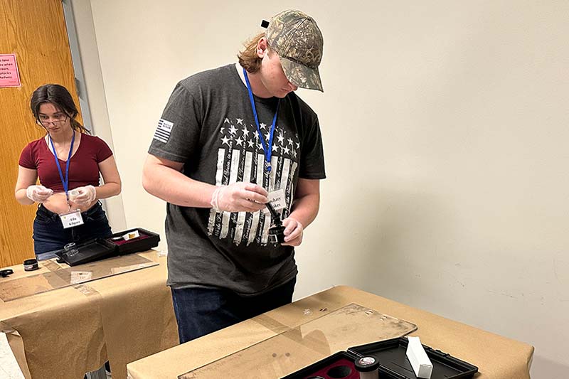 Young man using fingerprint kit