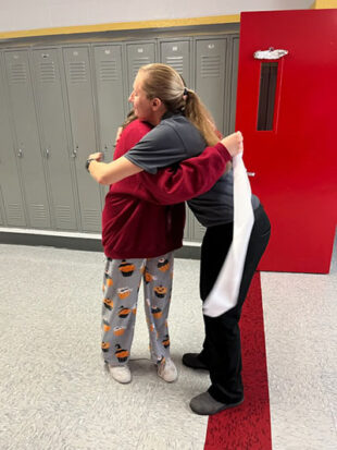 Student hugging teacher