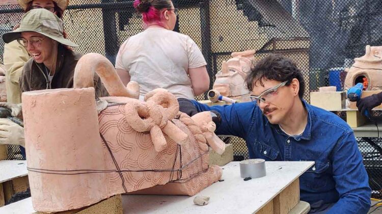 Male student working with ceramics