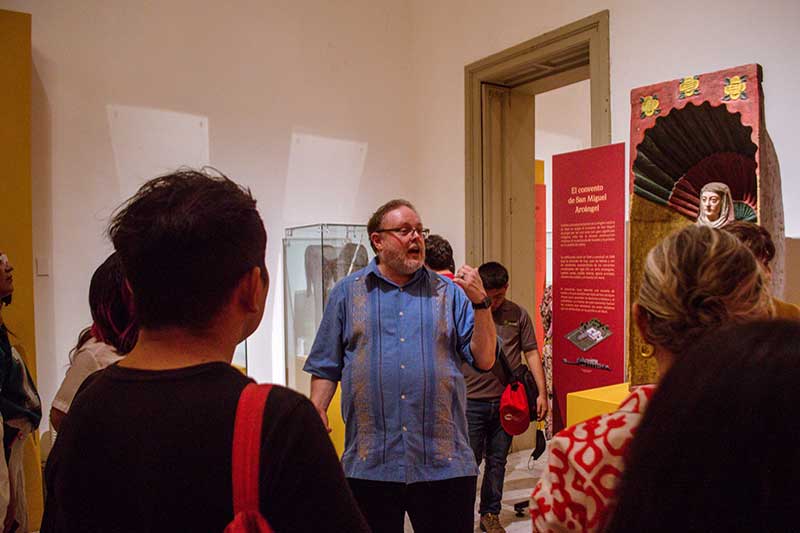 Man explaining an exhibit to a group