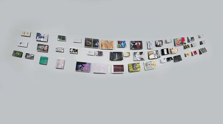 Three rows of artwork on wall