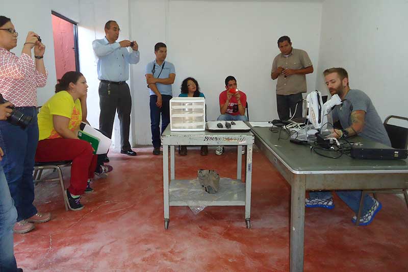 Man demonstrating archaeological equipment to group
