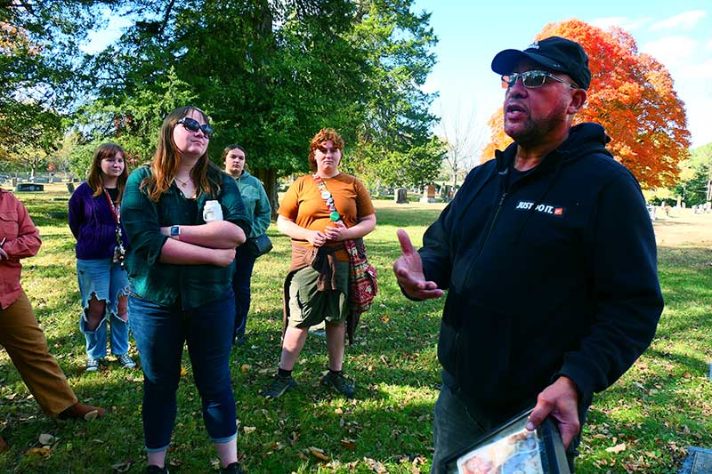 Man speaking to group outside