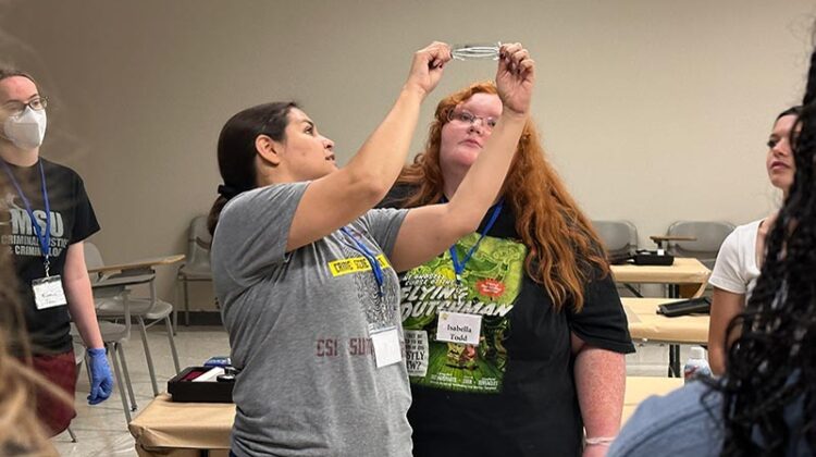 Woman demonstrating fingerprint technique to student